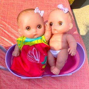Two baby dolls in a stroller used